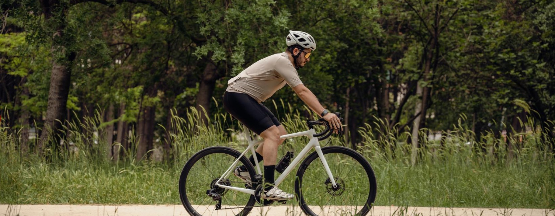 a man riding a bicycle on a park path